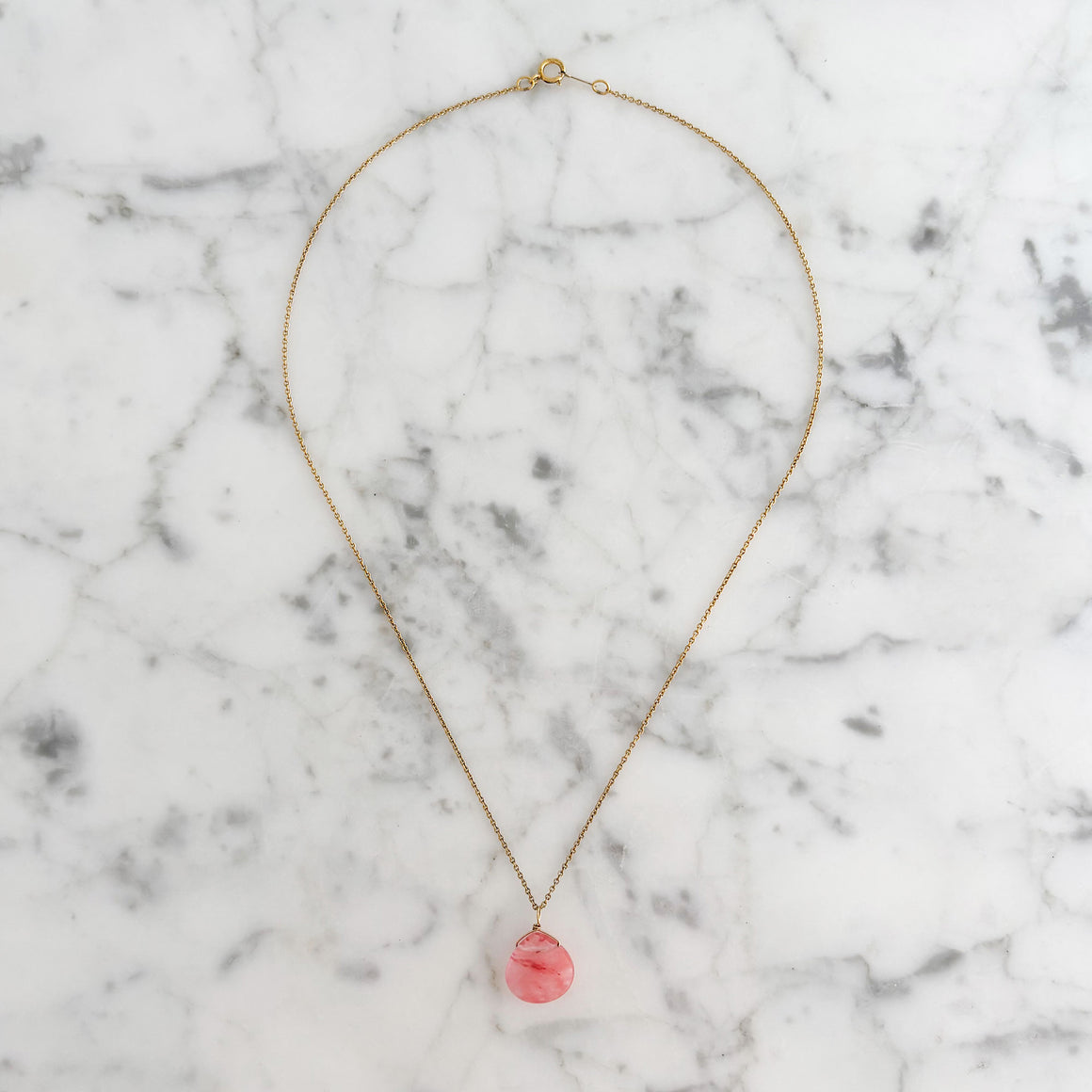 Woman wearing a faceted cherry quartz pendant necklace on a 14K gold-filled chain