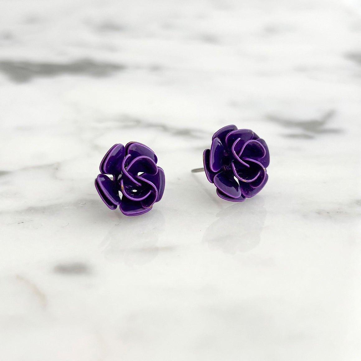 Woman wearing vintage purple enamel rose stud earrings