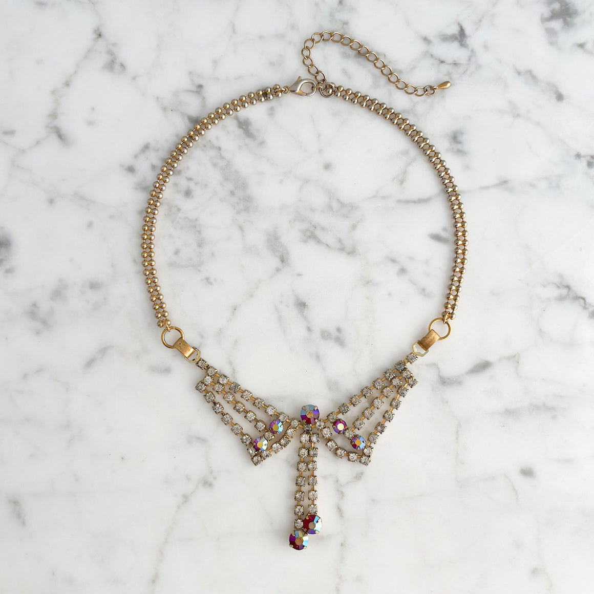 Woman wearing a vintage rhinestone choker with a sparkling red and clear pendant